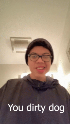 A Young Man Wearing Glasses And A Beanie Says " You Dirty Dog " GIF