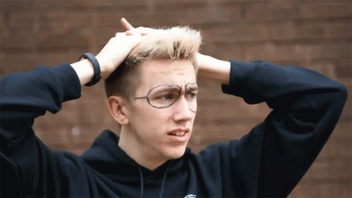 Young Man With Glasses And Black Hoodie Holding Head GIF