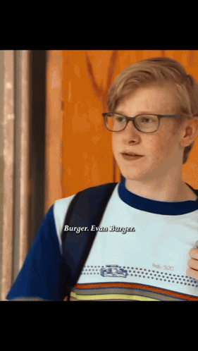 A Young Man Wearing Glasses And A Shirt That Says Burger GIF