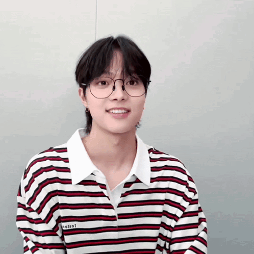 A Young Man Wearing Glasses And A Striped Shirt With The Word Instant On It GIF