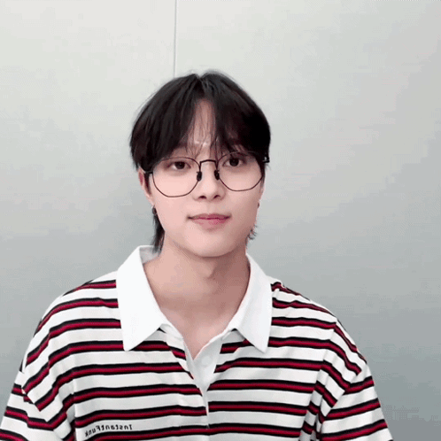 A Young Man Wearing Glasses And A Striped Shirt With The Word Vincent On The Front GIF