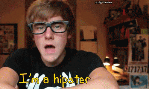 A Young Man Wearing Glasses And A T-Shirt That Says I 'M A Hipster GIF