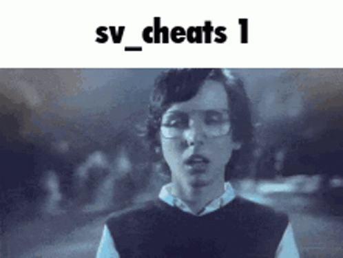 a young man wearing glasses and a vest is standing in front of a sign that says sv_cheats 1