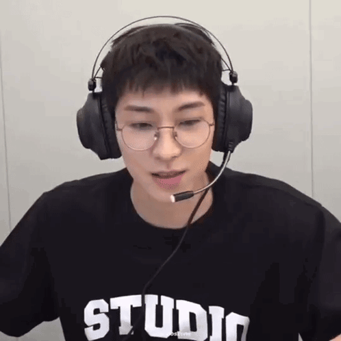 A Young Man Wearing Glasses And Headphones With The Word Studio On His T-Shirt GIF