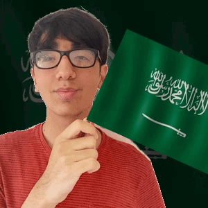 A Young Man Wearing Glasses Holds A Green Flag With Arabic Writing On It GIF