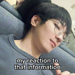 A Young Man Wearing Glasses Is Laying On A Couch With His Eyes Closed . GIF