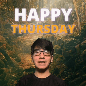 A Young Man Wearing Glasses Is Smiling In Front Of A Happy Thursday Sign GIF