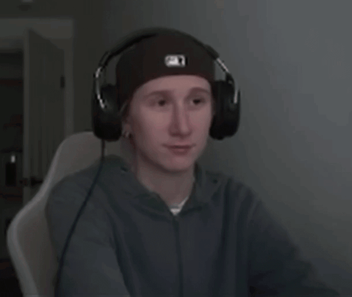 a young man wearing headphones and a beanie with the letter o on it