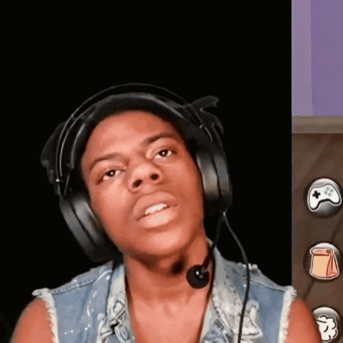 a young man wearing headphones and a microphone is looking at the camera
