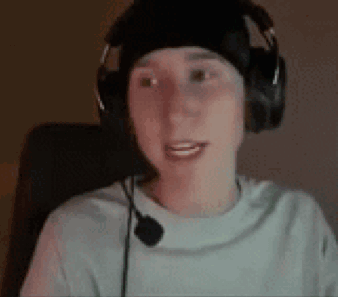 a young man wearing headphones and a microphone is sitting in a chair .