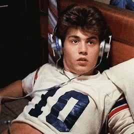 A Young Man Wearing Headphones And A Number 10 Jersey GIF