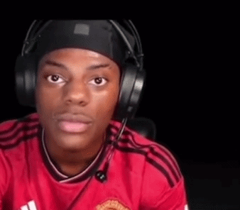 A Young Man Wearing Headphones And A Red Shirt Is Sitting In A Chair . GIF