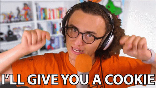 A Young Man Wearing Headphones And Glasses Says I 'Ll Give You A Cookie GIF