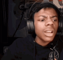 A Young Man Wearing Headphones Is Making A Funny Face . GIF