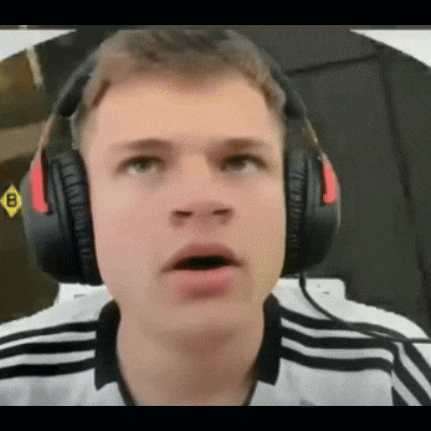 A Young Man Wearing Headphones Is Making A Surprised Face GIF