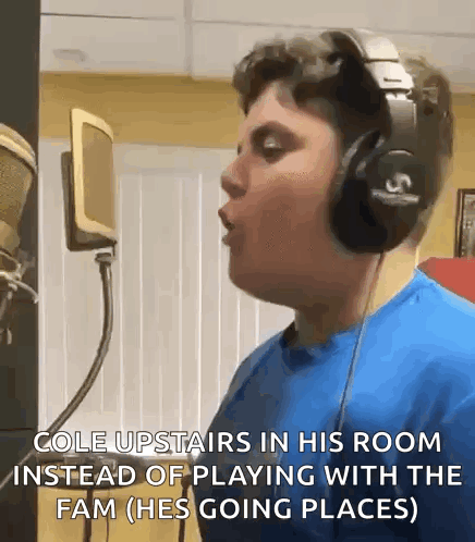 A Young Man Wearing Headphones Is Singing Into A Microphone .. GIF