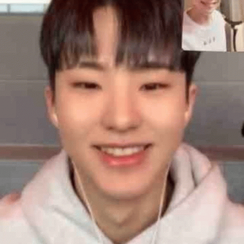 A Young Man Wearing Headphones Is Smiling While Having A Video Call With Another Young Man . GIF