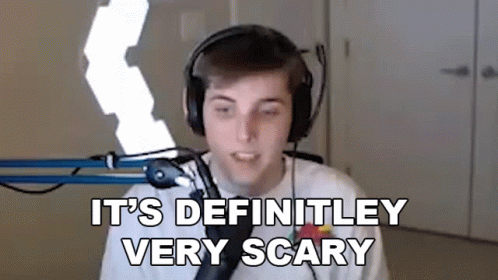 A Young Man Wearing Headphones Is Standing In Front Of A Microphone And Saying `` It 'S Definitely Very Scary '' GIF