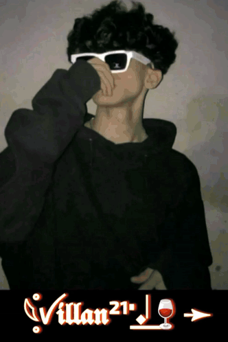 A Young Man Wearing Sunglasses And A Black Hoodie With Villan21 Written On The Bottom GIF