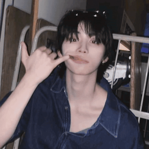 A Young Man Wearing Sunglasses And A Blue Shirt Is Making A Phone Call Sign GIF