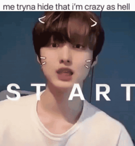 A Young Man With A Cat Ear On His Head Is Standing In Front Of A Sign That Says Start GIF