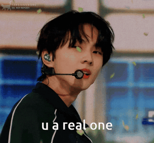 A Young Man With A Microphone In His Ear And The Words U A Real One Below Him GIF