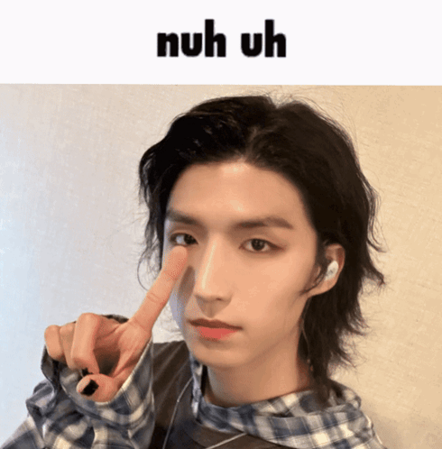 A Young Man With A Plaid Shirt Is Making A Funny Face With The Words Nuh Uh Above Him GIF