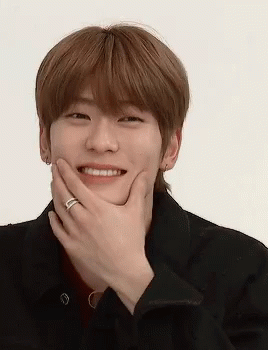 A Young Man With A Ring On His Finger Covering His Mouth With His Hand . GIF
