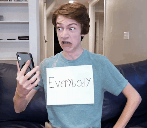 a young man with a sign that says everybody