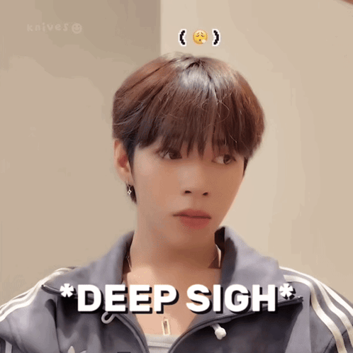 A Young Man With A Smiley Face On His Head Is Wearing A Jacket That Says Deep Sigh GIF