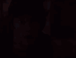 A Young Man With A Surprised Look On His Face Is Looking At The Camera . GIF