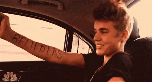 A Young Man With A Tattoo On His Arm That Says Believers GIF