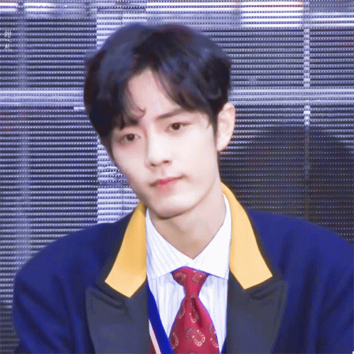 A Young Man With Blue Hair And A Red Tie GIF