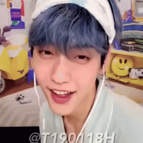 A Young Man With Blue Hair Is Wearing A Headband And Headphones . GIF