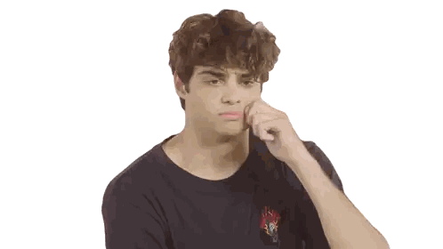 a young man with curly hair is making a face