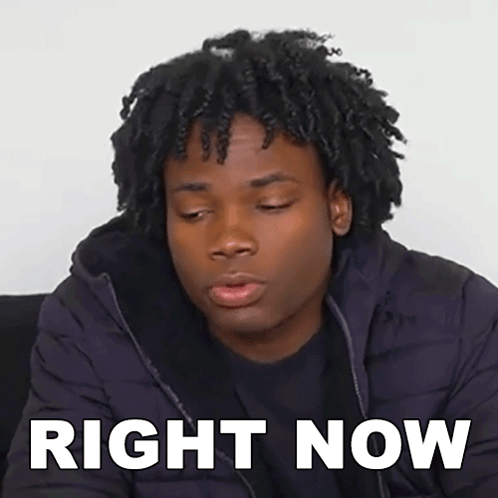 A Young Man With Curly Hair Is Wearing A Black Jacket And Has The Words Right Now Written On His Face . GIF