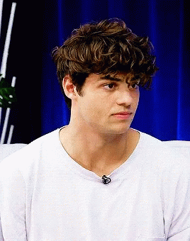 A Young Man With Curly Hair Wearing A White T-Shirt GIF