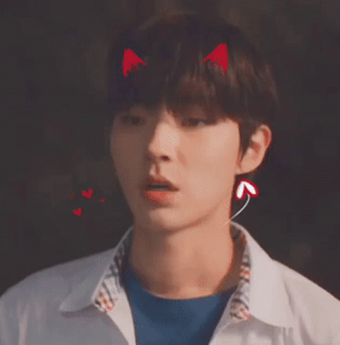 A Young Man With Devil Horns On His Head Wearing Ear Buds . GIF