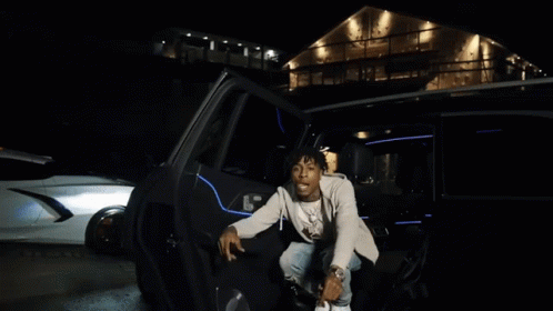 A Young Man With Dreadlocks Is Sitting In A Car And Smiling GIF