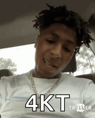 A Young Man With Dreadlocks Is Wearing A White Shirt And A Chain Around His Neck And Says 4Kt GIF