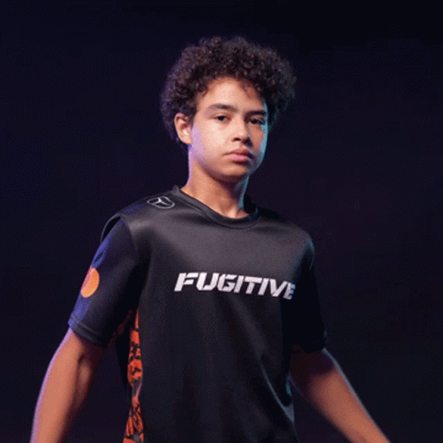 A Young Man With His Arms Crossed Is Wearing A Shirt That Says Ativ GIF