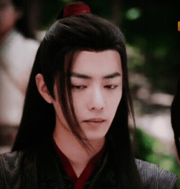 A Young Man With Long Hair Has A Red Ponytail GIF