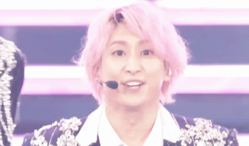 A Young Man With Pink Hair Is Wearing A Microphone And Making A Funny Face GIF
