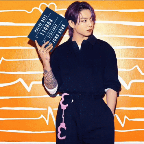 A Young Man With Purple Hair Is Holding Up A Police Department Mug Shot GIF