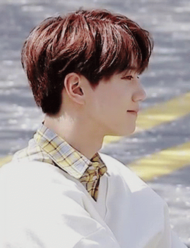 a young man with red hair and a plaid shirt