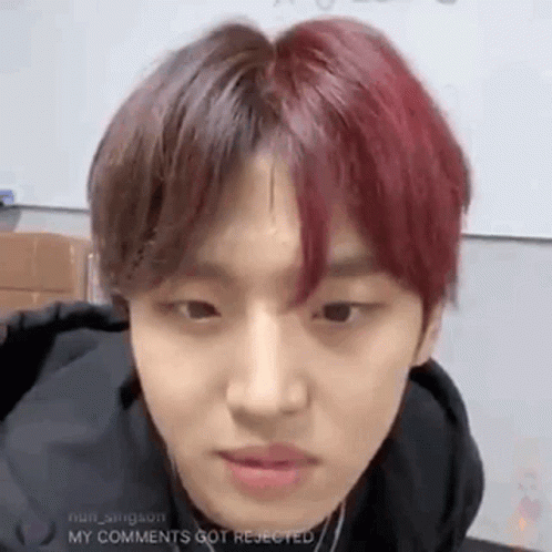 A Young Man With Red Hair Is Looking At The Camera . GIF