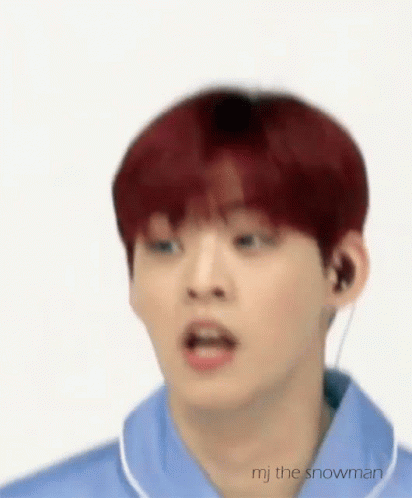A Young Man With Red Hair Is Wearing A Blue Shirt And Earphones . GIF