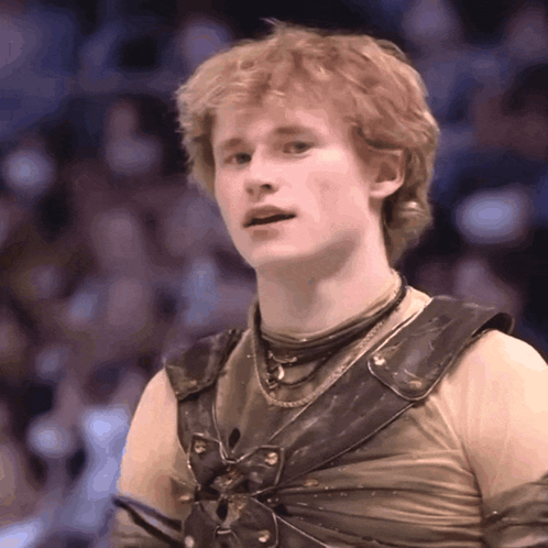 A Young Man With Red Hair Is Wearing A Costume With A Butterfly On It GIF