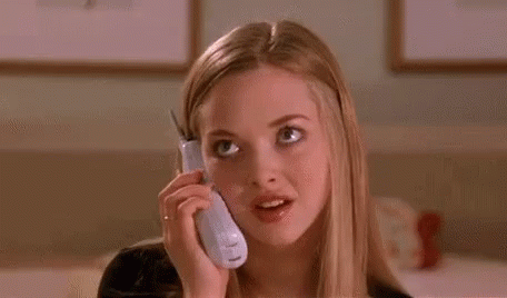 A Young Woman Is Talking On A Cell Phone And Making A Funny Face . GIF