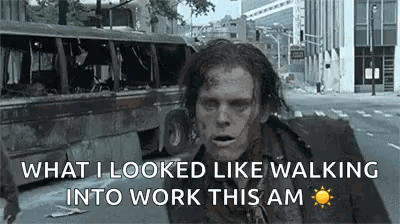A Zombie Is Walking Down A Street In A City . GIF